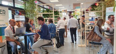 Tables de rendez-vous entre fournisseurs locaux et acheteurs publics et privés, bannière Niort Agglo visible en arrière-plan.