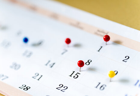 Closeup Colorful drawing pins on Calendar page with date